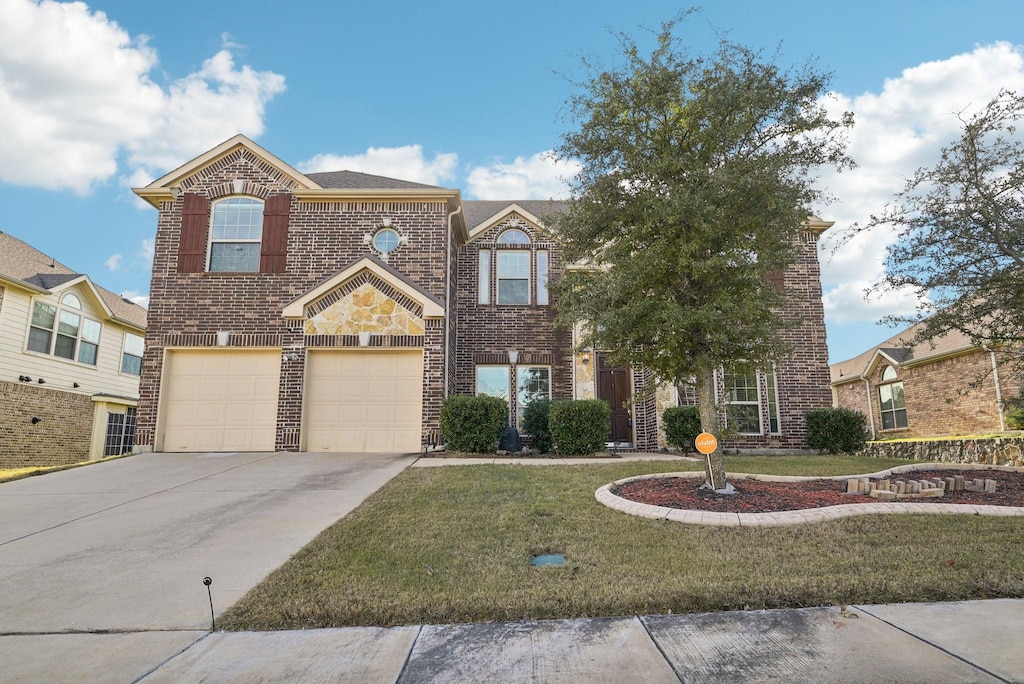 view of front of property with a front lawn and a garage