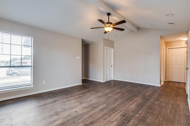 unfurnished room featuring ceiling fan, lofted ceiling with beams, and dark hardwood / wood-style floors