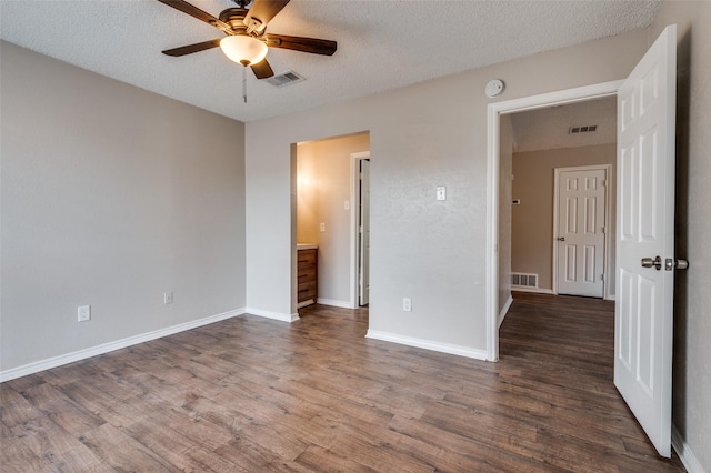 unfurnished bedroom with a textured ceiling, ceiling fan, and dark hardwood / wood-style floors