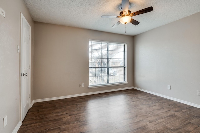 spare room with a textured ceiling, ceiling fan, and dark hardwood / wood-style flooring