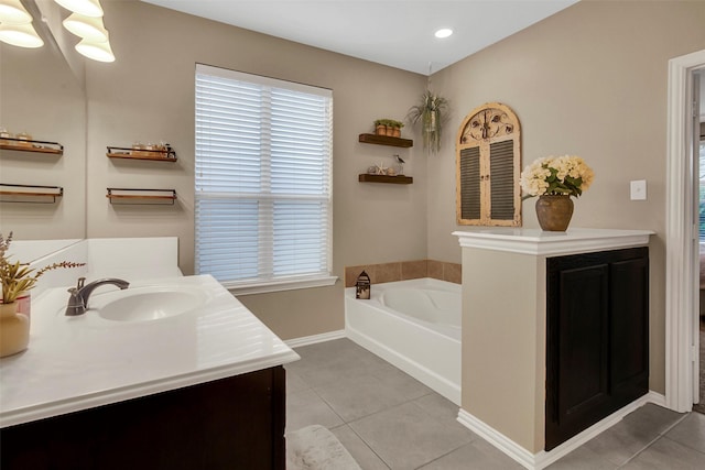 bathroom with vanity, a bathtub, and tile patterned flooring