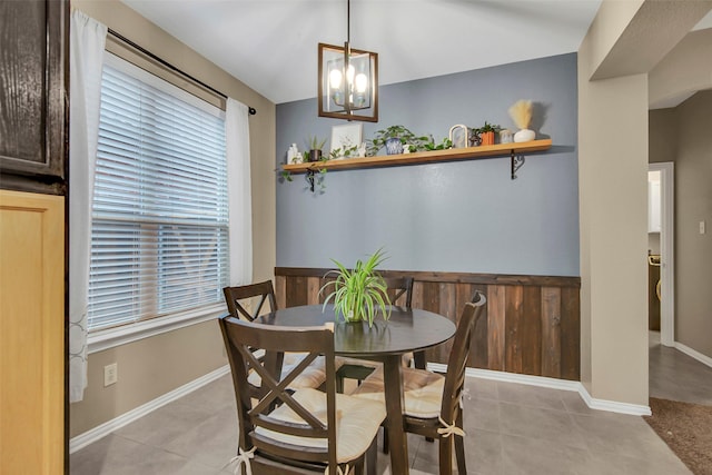 tiled dining space with an inviting chandelier