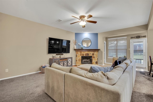 living room with light carpet, a fireplace, and ceiling fan