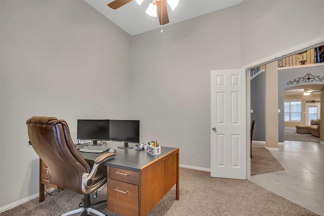 carpeted home office featuring high vaulted ceiling and ceiling fan