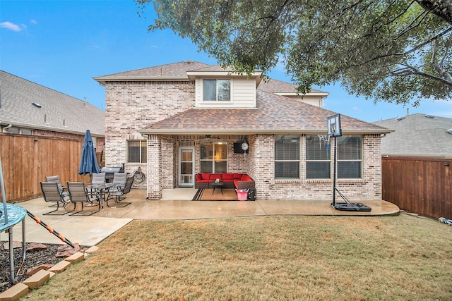 back of property featuring an outdoor hangout area, a lawn, and a patio area