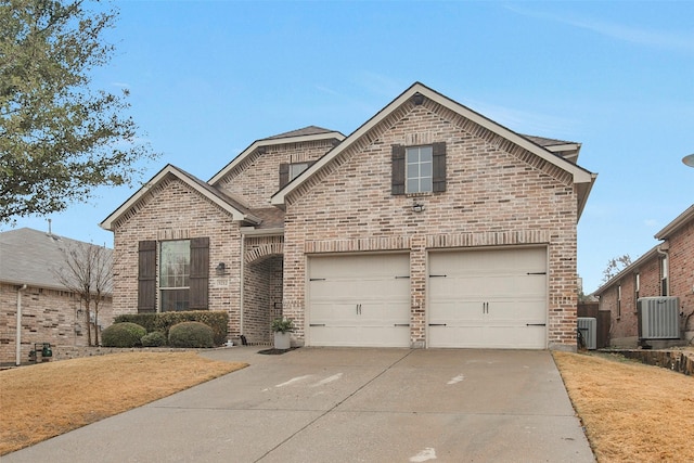 front of property featuring cooling unit and a garage