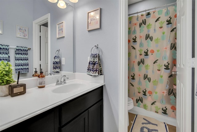 full bathroom featuring vanity, shower / bath combination with curtain, and toilet