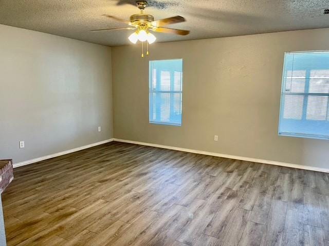 empty room with a textured ceiling, ceiling fan, and hardwood / wood-style floors