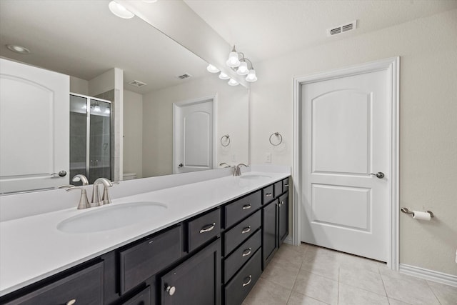 bathroom with toilet, an enclosed shower, vanity, and tile patterned flooring