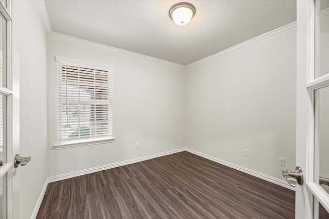 unfurnished room featuring ornamental molding and dark hardwood / wood-style flooring