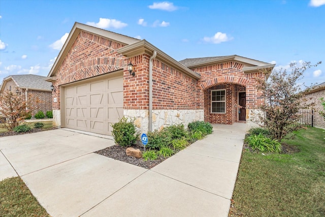 view of front property featuring a garage and a front lawn