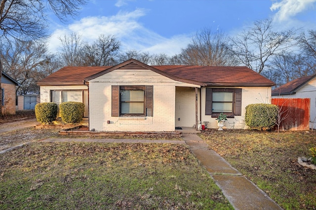 bungalow-style home with a front lawn