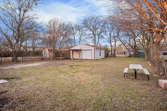 view of yard featuring a garage and an outdoor structure