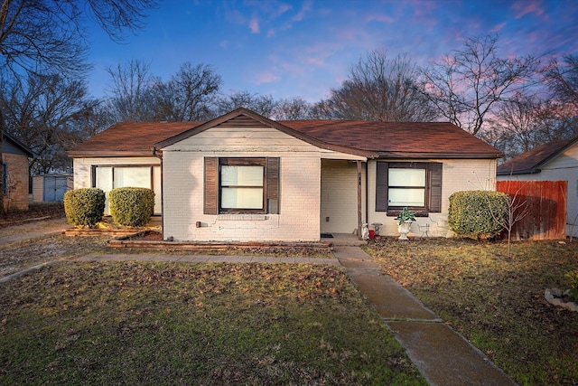 bungalow-style house featuring a lawn