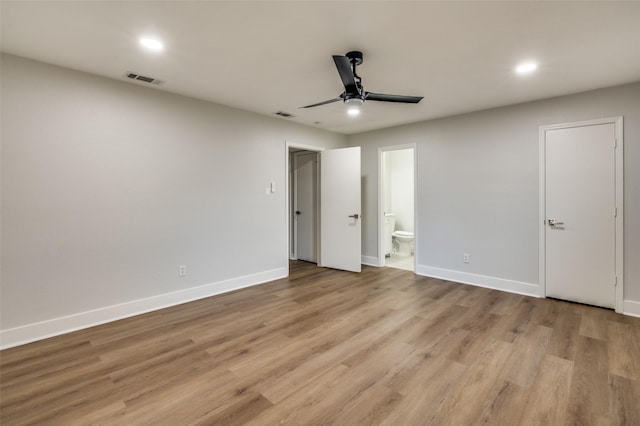 unfurnished bedroom featuring ensuite bathroom, ceiling fan, and light hardwood / wood-style flooring