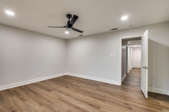 empty room featuring hardwood / wood-style flooring and ceiling fan