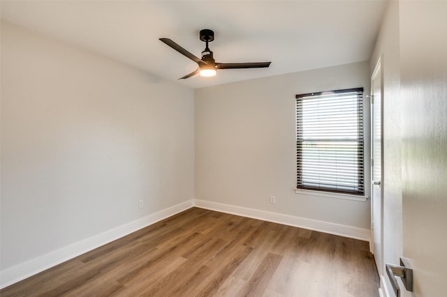 empty room with ceiling fan and wood-type flooring