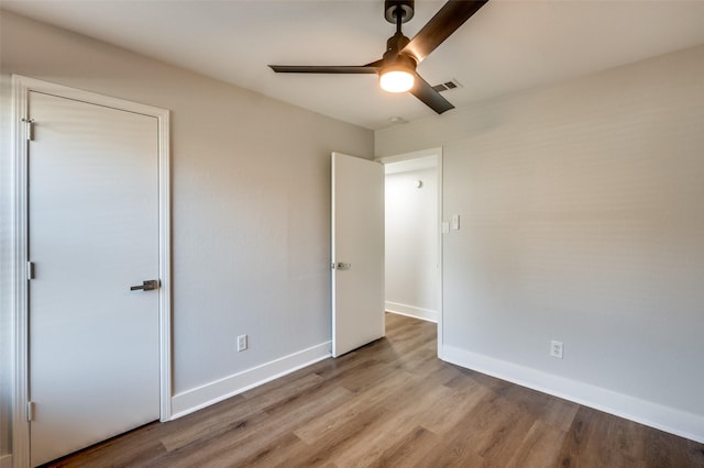 unfurnished bedroom with ceiling fan and light hardwood / wood-style floors