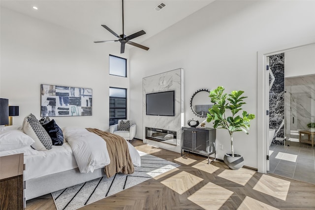 bedroom featuring ceiling fan, a towering ceiling, visible vents, and recessed lighting