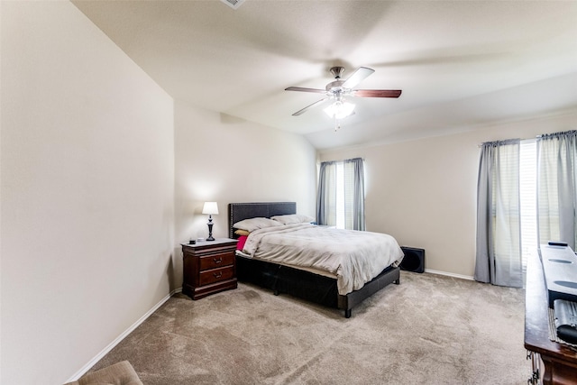 bedroom with ceiling fan, light carpet, and multiple windows