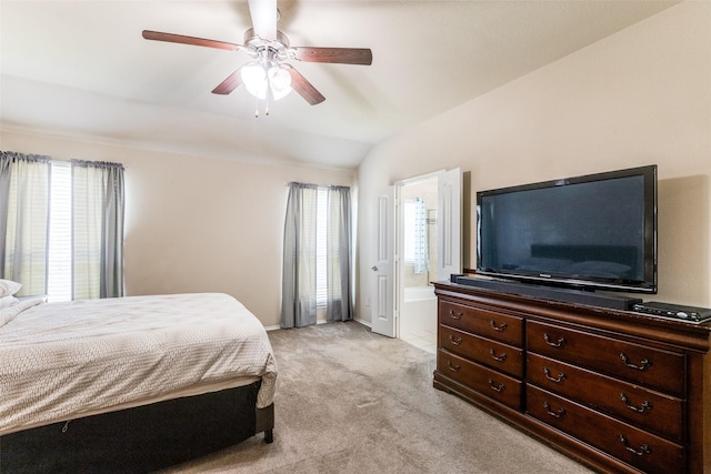 bedroom with light carpet, ensuite bathroom, ceiling fan, lofted ceiling, and multiple windows