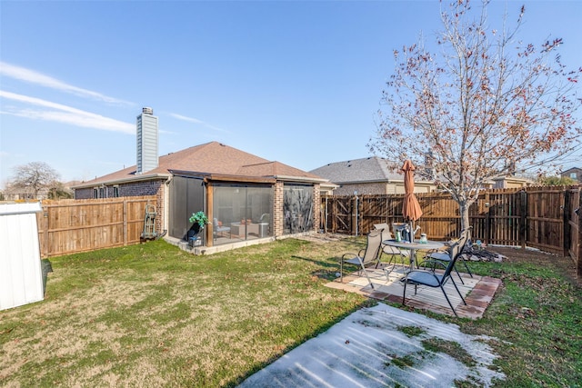 view of yard with a sunroom and a patio