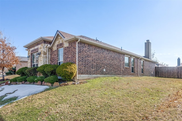 view of side of home with a lawn