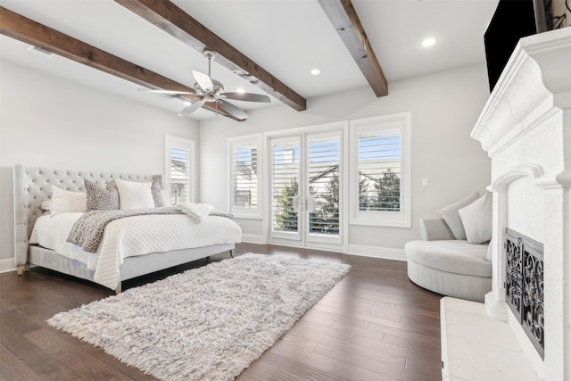 bedroom featuring recessed lighting, dark wood-style flooring, a fireplace with raised hearth, baseboards, and beam ceiling