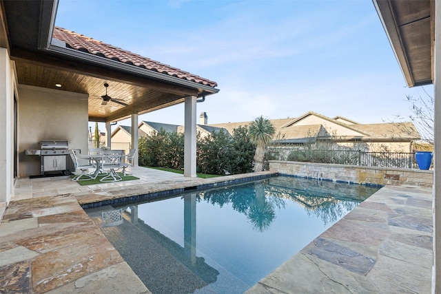 view of pool with a patio area, grilling area, and ceiling fan