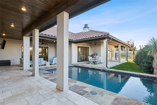 view of swimming pool with a patio and ceiling fan