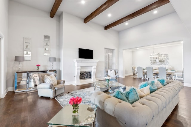 living room featuring beam ceiling, a towering ceiling, and dark hardwood / wood-style floors