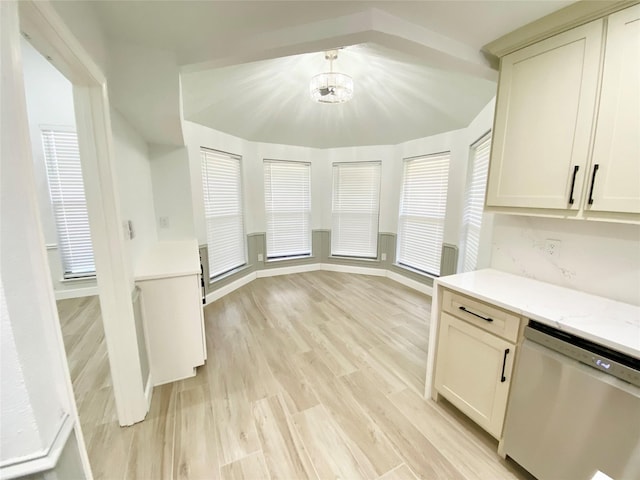 kitchen with stainless steel dishwasher, a chandelier, light hardwood / wood-style floors, and light stone counters