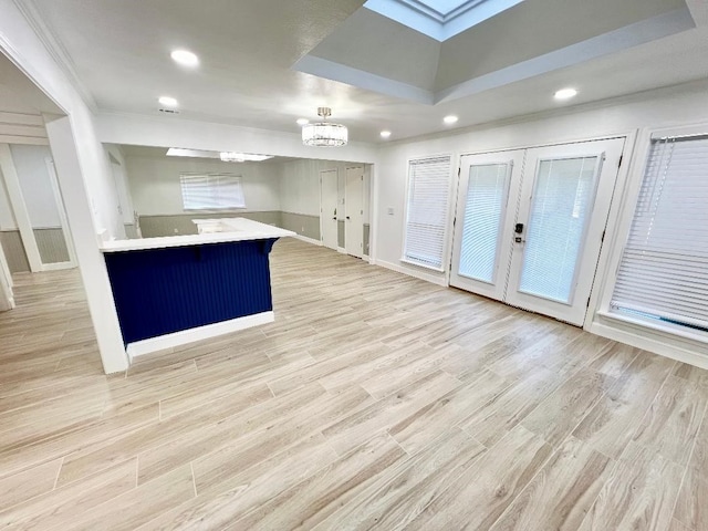 kitchen with light hardwood / wood-style flooring, a notable chandelier, and kitchen peninsula