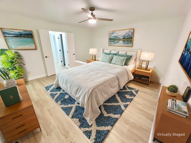 bedroom with light hardwood / wood-style floors and ceiling fan