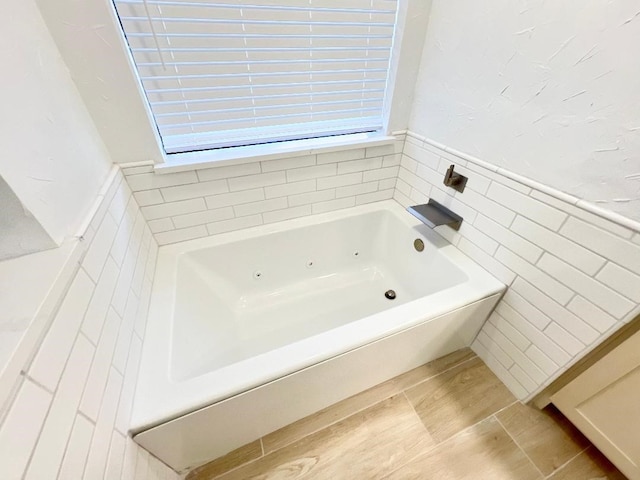 bathroom featuring tile patterned flooring and a bathtub