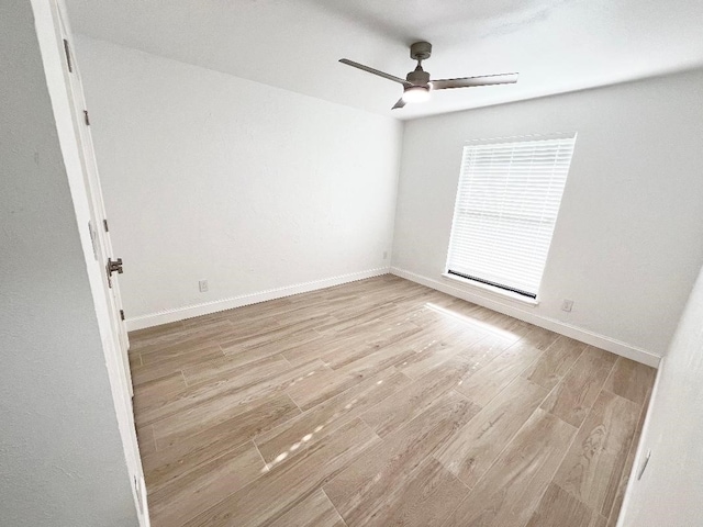 spare room featuring ceiling fan and light hardwood / wood-style floors