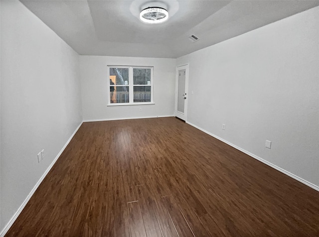 spare room featuring dark hardwood / wood-style flooring