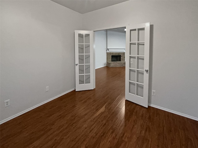 empty room with french doors and dark hardwood / wood-style floors