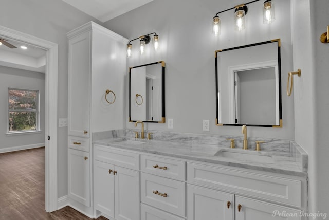 bathroom with ceiling fan, vanity, and hardwood / wood-style flooring