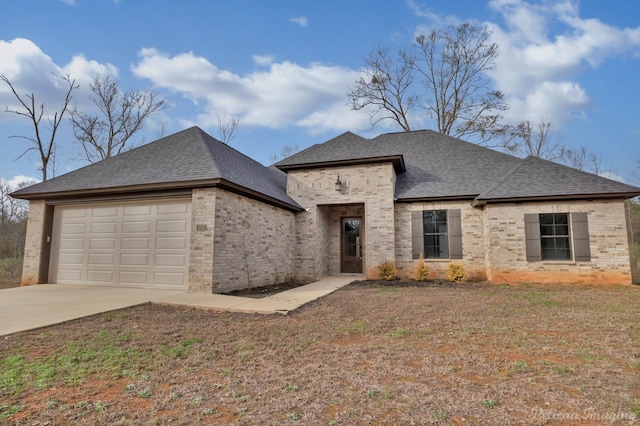 view of front of home featuring a garage and a front lawn