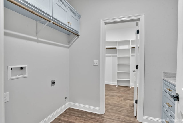 laundry area featuring electric dryer hookup, hookup for a washing machine, and dark hardwood / wood-style floors