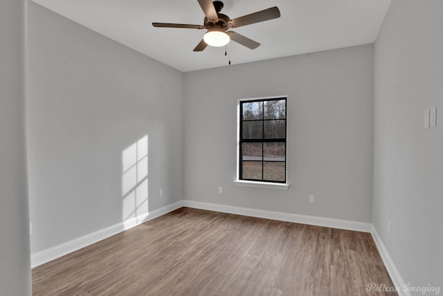 spare room featuring ceiling fan and hardwood / wood-style floors