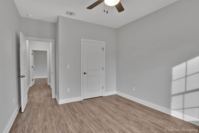 unfurnished bedroom featuring ceiling fan and light wood-type flooring