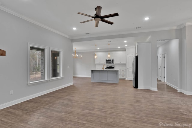 unfurnished living room featuring ornamental molding, light hardwood / wood-style flooring, and ceiling fan with notable chandelier