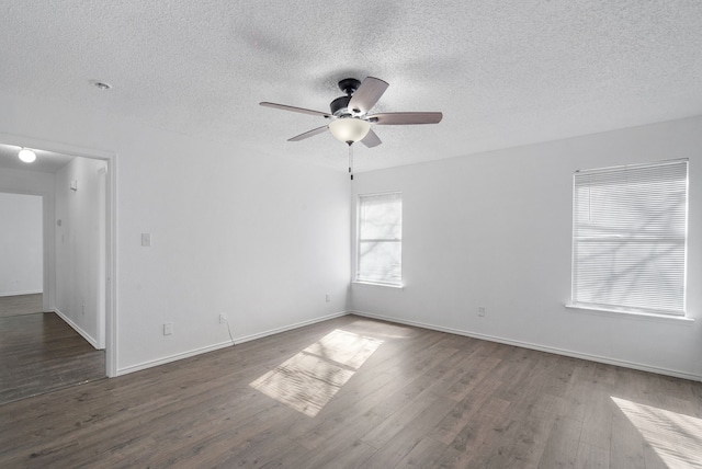 unfurnished room with ceiling fan, dark hardwood / wood-style flooring, and a textured ceiling