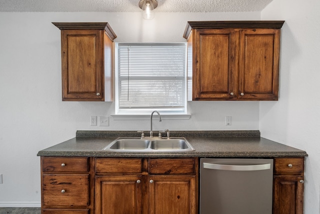 kitchen featuring sink, stainless steel dishwasher, and a textured ceiling