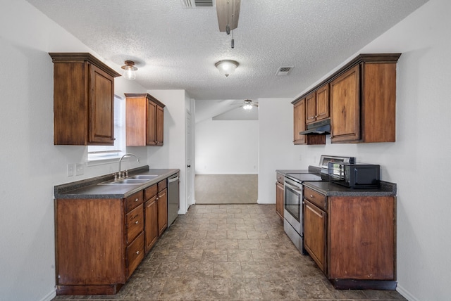 kitchen with a textured ceiling, appliances with stainless steel finishes, ceiling fan, and sink