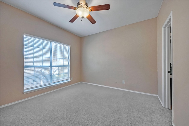 empty room featuring ceiling fan and light colored carpet