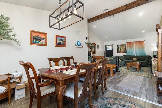 dining area with vaulted ceiling with beams and hardwood / wood-style flooring