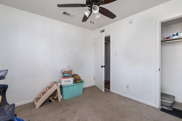 interior space featuring ceiling fan and carpet flooring